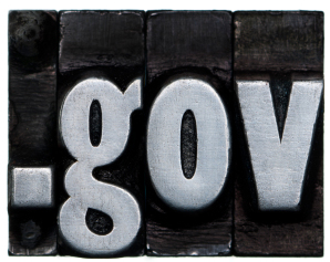 A close-up image of four metallic letterpress type blocks spelling ".gov" in lowercase, reflecting the secure access needed for employment data. The letters are arranged from left to right against a dark background.