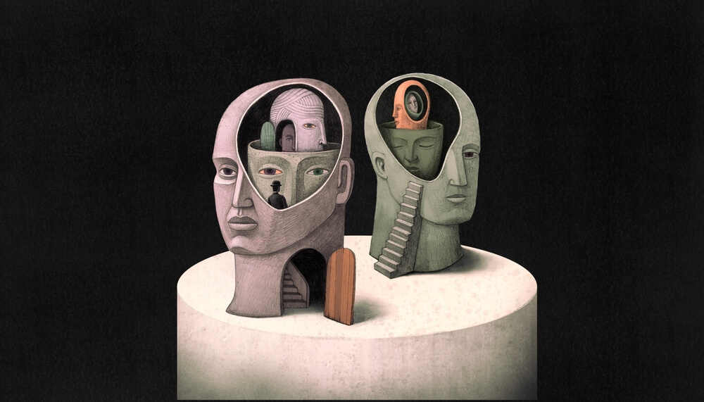 Two stylized human head sculptures with intricate inner sections are displayed on a round pedestal. One head is open, revealing various faces and a staircase; another exposes a winding stair leading to a portrait. A small door stands between them, symbolizing the gateways to intelligence.