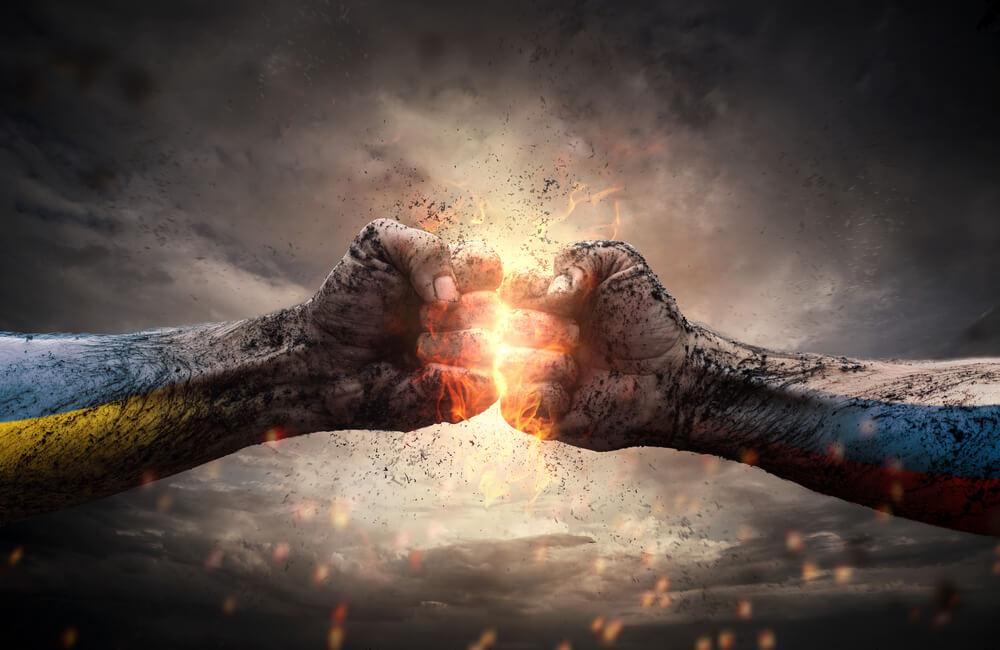 Two fists covered in dirt and grime are clasping together against a dramatic cloudy backdrop. The point of contact is illuminated with a bright, fiery glow, and sparks fly around, symbolizing power and struggle. One arm has blue and yellow, the other red and blue markings—a visual metaphor for workplace conflict.